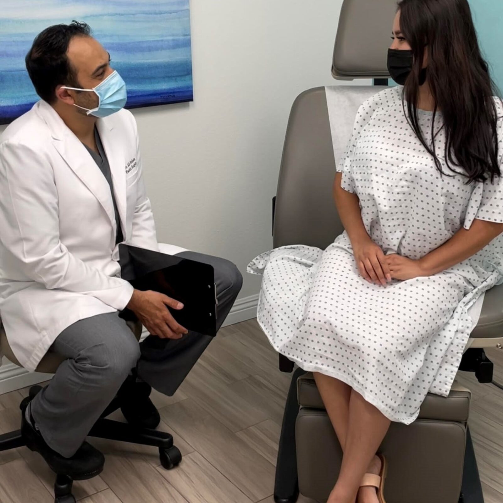 Dr. Ali Roham talking with a patient during a consultation